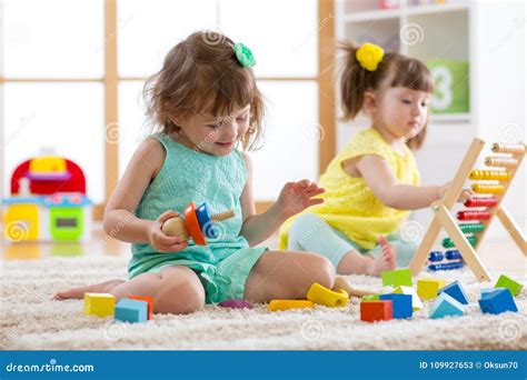 Kids are Engaging in Daycare. Two Toddler Children Playing with ...