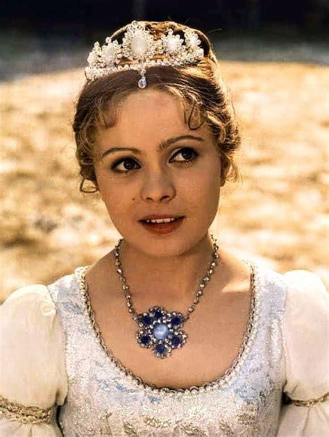 A Woman Wearing A Tiara With Pearls On Her Head And Dress Is Posing For