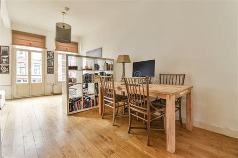 A Dining Room With A Wooden Table And Chairs Editorial Photography