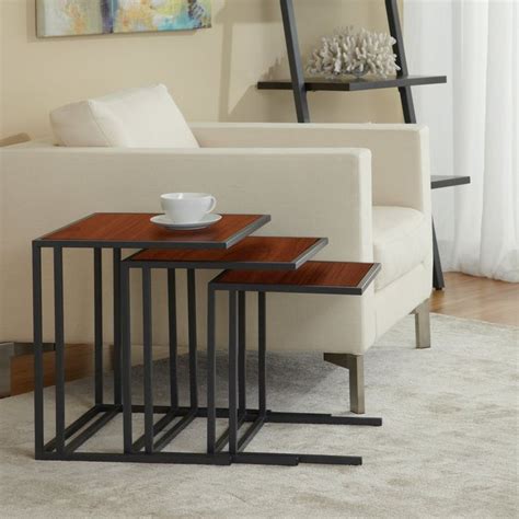 Three Black Nesting Tables Sitting On Top Of A Carpeted Floor Next To A