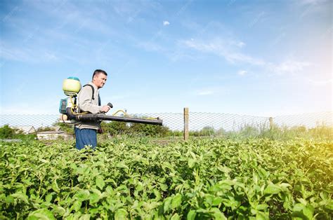 premium photo  farmer   pesticide sprayer machine walks