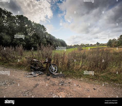 Stolen Burned Out And Abandoned Motorcycle In The Countryside Stock