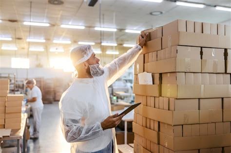 Premium Photo The Food Factory Inspector In A White Sterile Uniform