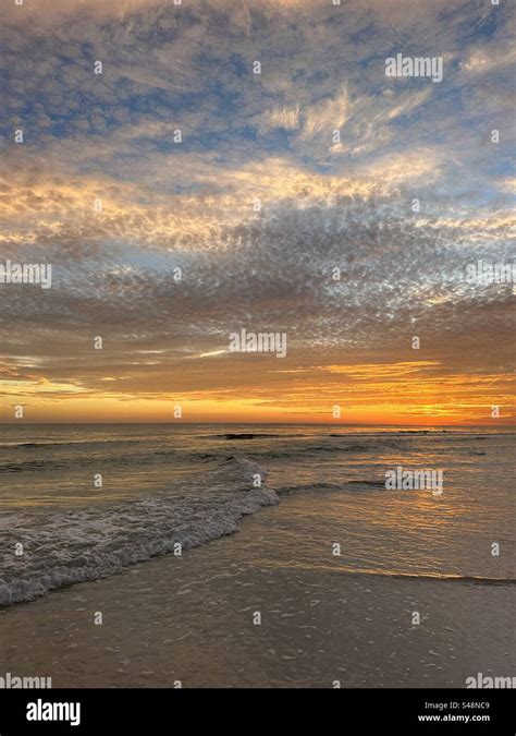 Layers Of Colorful Sunset Clouds Over The Gulf Of Mexico Water In