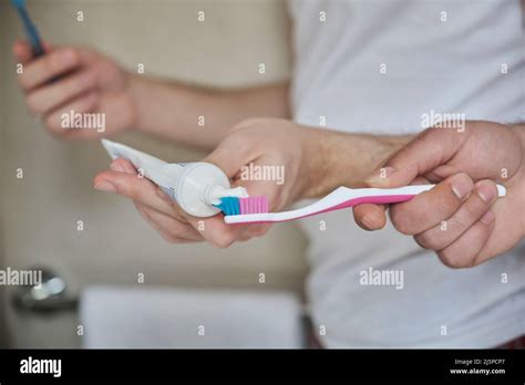 Unrecognizable Gay Couple Putting Toothpaste On The Toothbrush In The Bathroom Stock Photo Alamy