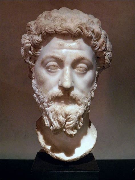 A White Marble Bust Of A Man With Long Hair And Beard