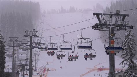 Ski Lift On Ski Resort Skiers Climb On A Ski Chair Elevator Up To Ski