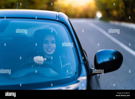A Beautiful Brunette Driver Smiles In Her New Car Stock Photo Alamy