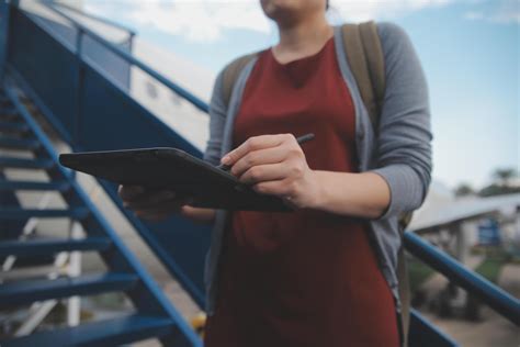Blonde female tourist checking incoming notification on smartphone