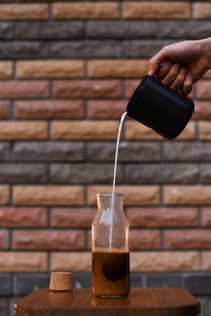 Premium Photo The Process Of Pouring Milk In Coffee