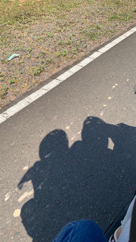 The Shadow Of A Person Riding A Skateboard In Front Of A Park Bench And