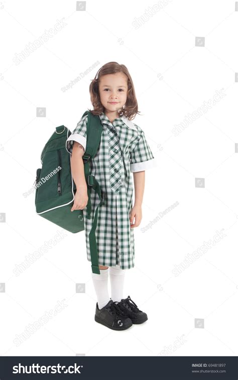 Primary School Girl In Uniform With School Bag Over Shoulder Isolated