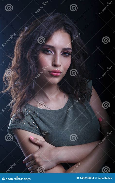 Beautiful Makeup Brunette Model With Curly Hair Looking On A Dark Background Close Up Of A