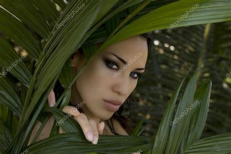 Sexy Beautiful Woman Hiding Behind The Palm Leaves Beautiful St Stock