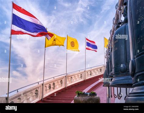 Thai National Buddhist And Thai Royal Flags At Red Staircase And Bells