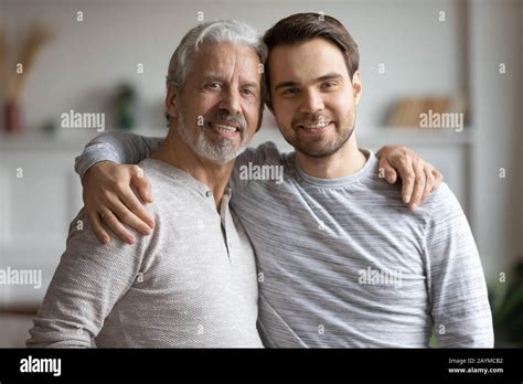Elderly Mature Dad Cuddling Shoulders Of Grownup Son Stock Photo Alamy
