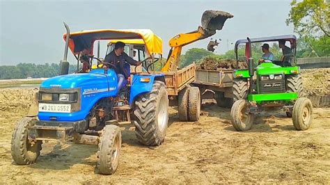 Jcb Dx Backhoe Machine Loading Pond Mud In Mahindra Sonalika And