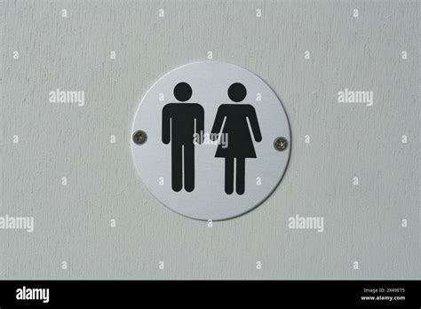 Toilet Sign On A Door A Brushed Aluminium Lavatory Symbols Screwed To A Door Both Sexes Mixed