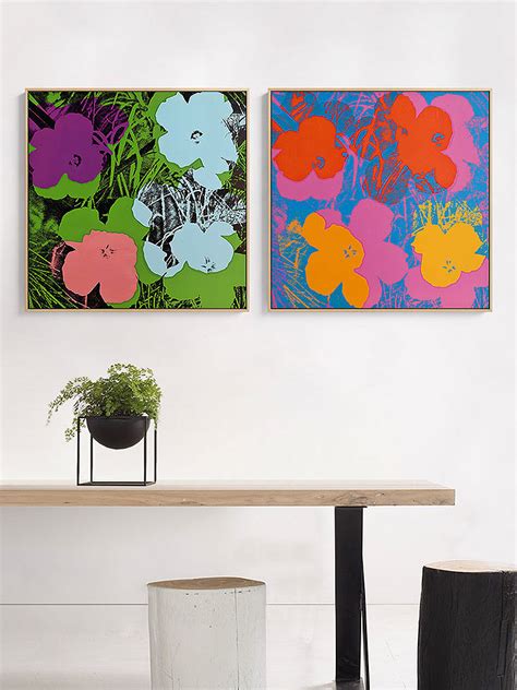 Two Paintings Are Hanging On The Wall Above A Table