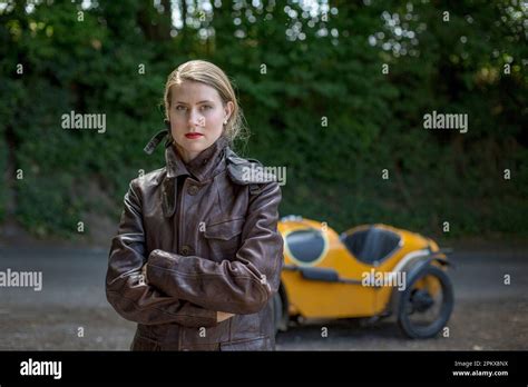 Blonde Girl With Leather Coat In Front Of Vintage Car Stock Photo Alamy