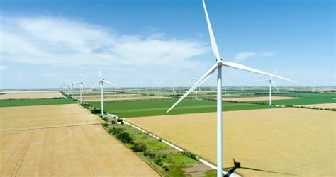 Group Of Windmills For Electric Power Production In Heavy Rain Stock