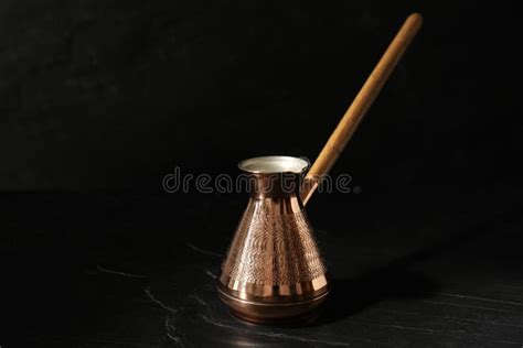 Beautiful Copper Turkish Coffee Pot With Wooden Handle On Black Table