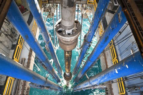 High Angle View Of Drilling Riser And Pipes In Sea At Oil Rig Stock Photo