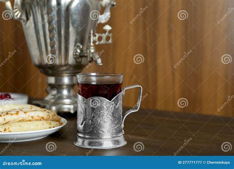 Vintage Samovar Cup Of Hot Drink And Pancakes Served On Wooden Table