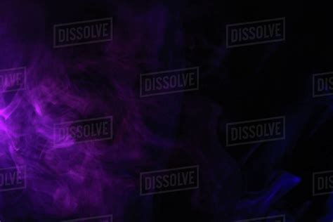 Abstract Black Background With Purple Smoke Studio Shot Stock Photo