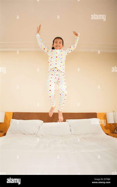 Kid Jumping on Bed Stock Photo - Alamy