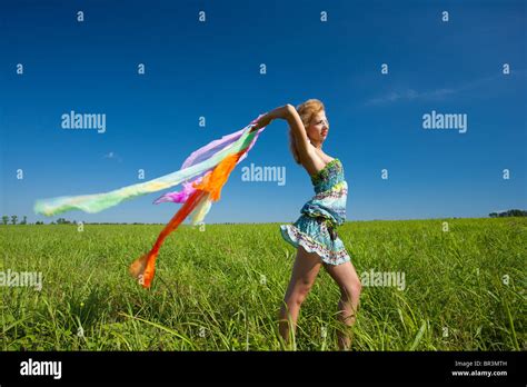 Beautiful Blonde Woman With Colorful Scarf In The Wind Motion Blur Stock Photo Alamy