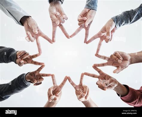 Below Hands In Circle Making A Star Shape A Group Of People Putting