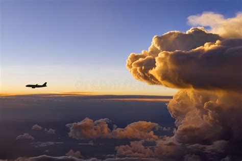 Airplane Storm Flying In The Orange Sky With Clouds At Colorful Sunset ...