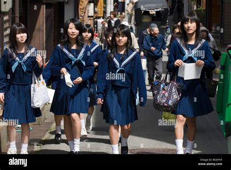 A Group Of High School Girls Wearing Sailor Uniforms Enjoying A Stroll