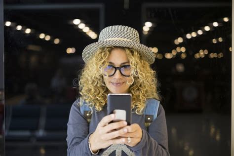 Portrait And Close Up Of Beautiful Curly And Blonde Woman Looking At The Camera Smiling Happy