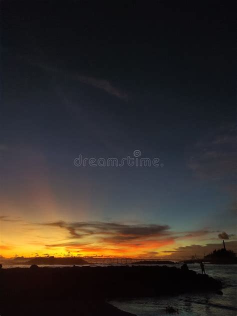 Beautiful Sunset on the Beach with the Silhouette of a Breakwater Stock ...