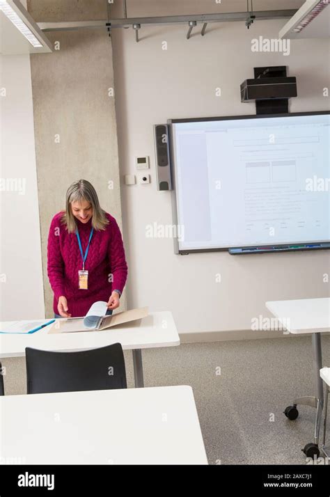 Mature Female Instructor Preparing In Classroom Stock Photo Alamy