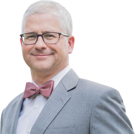 a man wearing glasses and a bow tie