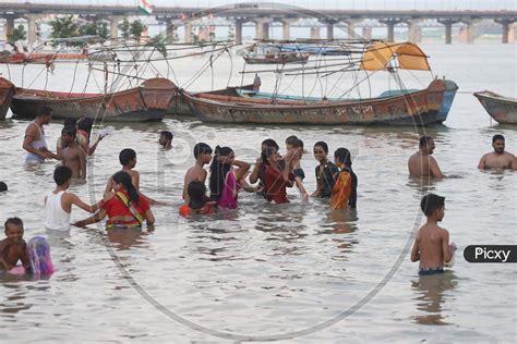 Image Of Hindu Devotees Taking Holy Bath In Triveni Sangam River At