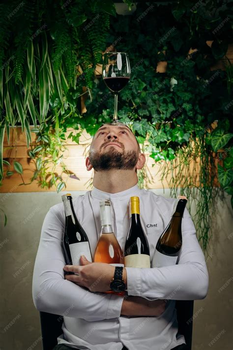 Premium Photo | Professional chef and sommelier holding a glass and