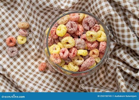 Breakfast Cereal Concept Colorful Ring Cereals In Glass Jar And Falling On Gingham Cloth Stock