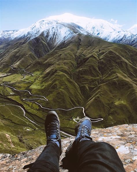 Premium Photo Low Section Of Man Sitting On Mountain