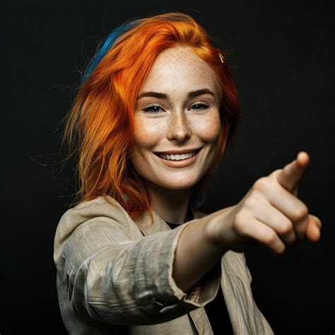 Premium Photo A Woman With Red Hair Pointing At The Camera