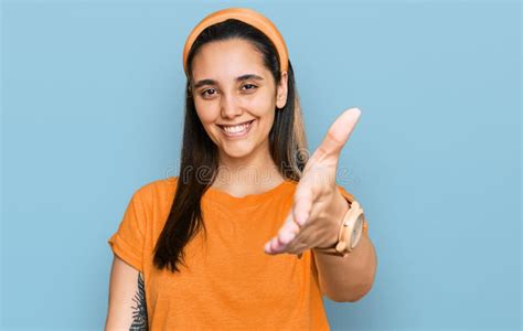 Young Hispanic Woman Wearing Casual Clothes Smiling Friendly Offering