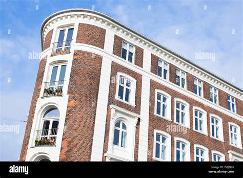 Red Brick Architecture With The Windows Reflecting The Blue Sky In