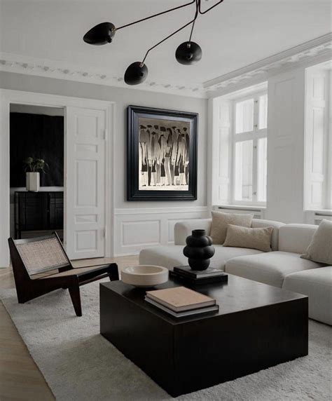 A Living Room Filled With Furniture And Lots Of Windows In Its Center Area