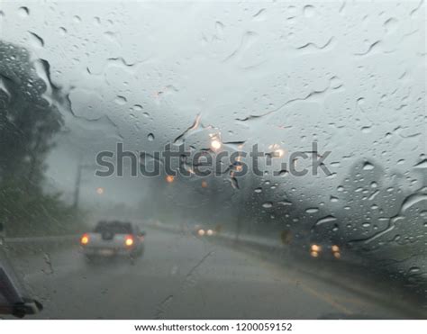 Road View Through Car Window Blurry With Heavy Rain Driving In Rain