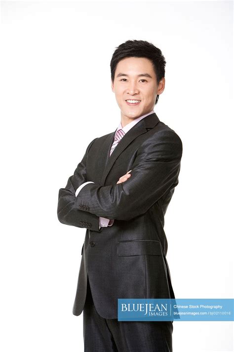 Three Quarters Length Chinese Businessman Smiling With Arms Crossed