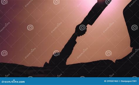 Man Helping Female Climber Up A Mountainsilhouette Of A Man Gives A