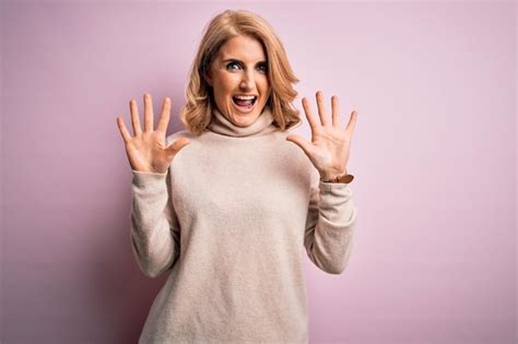 Premium Photo Middle Age Beautiful Blonde Woman Wearing Casual Turtleneck Sweater Over Pink